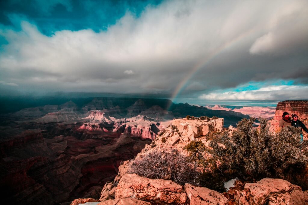 pexels-photo-405127-405127 Stunning view of a rainbow arching over the Grand Canyon, capturing the majestic red rock formations under a dramatic sky.
